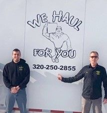 Two men stand by a truck with 