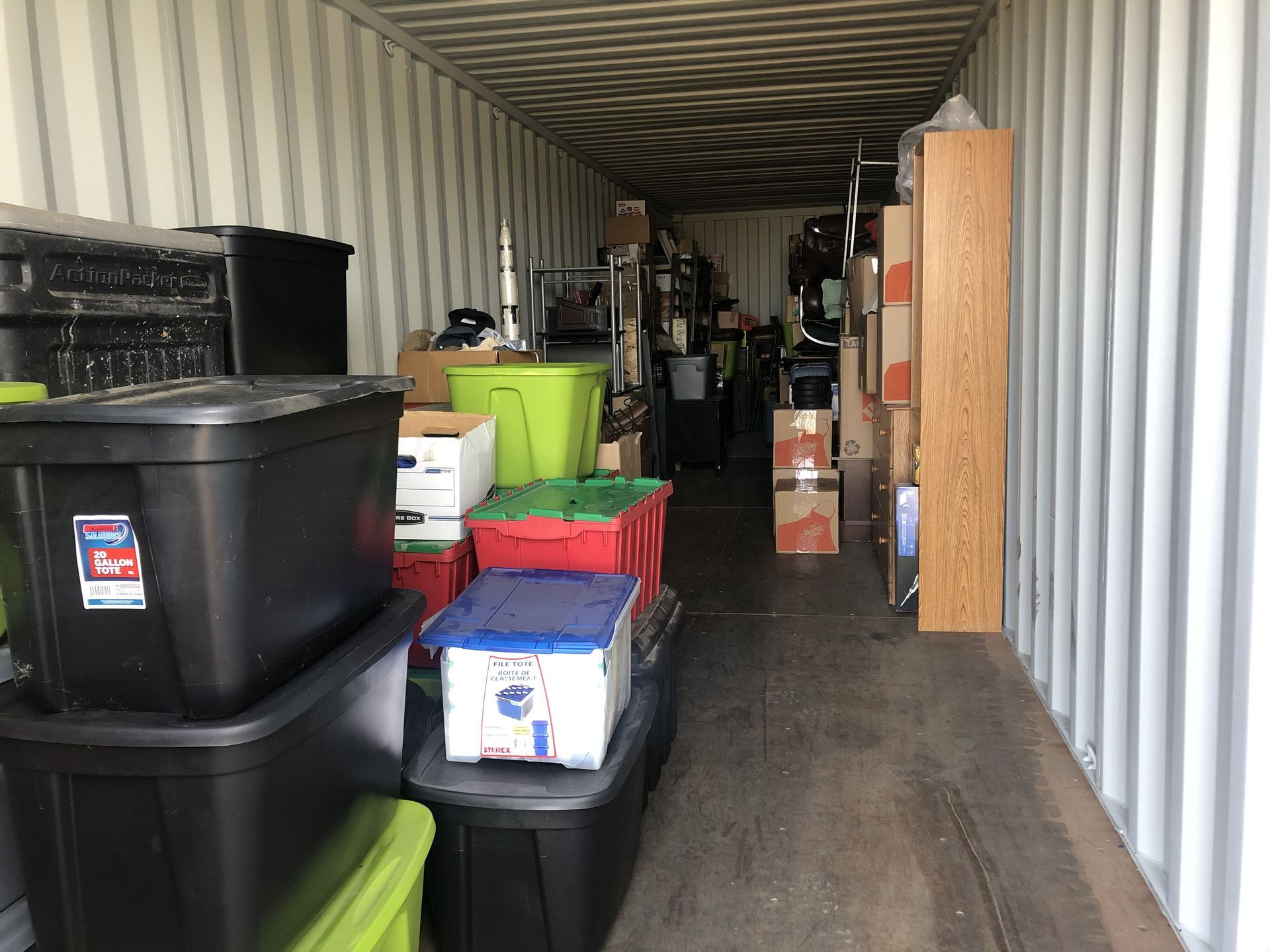 Woman and older woman smiling, indoors. Woman in red shirt, other in navy blazer.