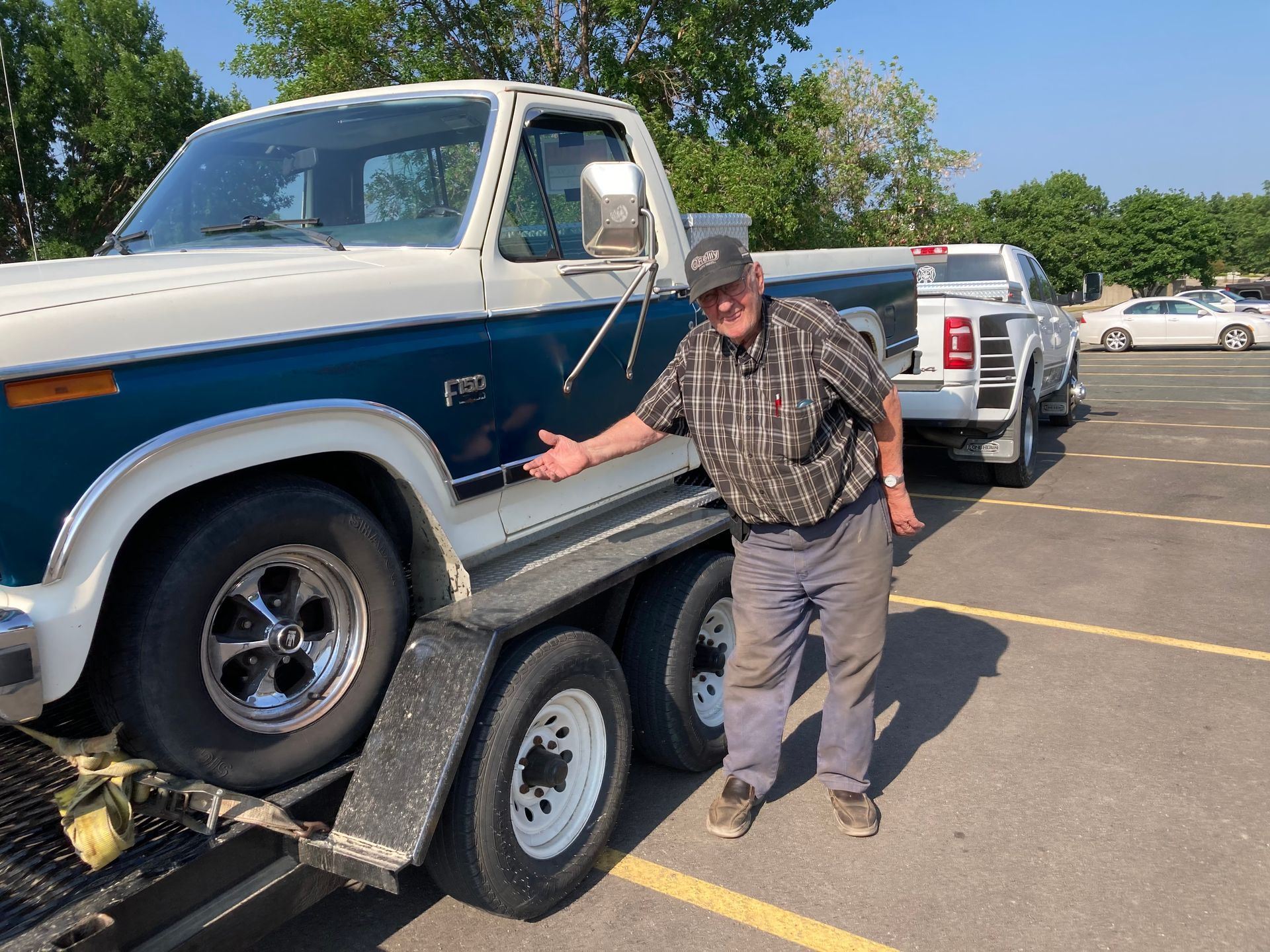 Woman and older woman smiling, indoors. Woman in red shirt, other in navy blazer.