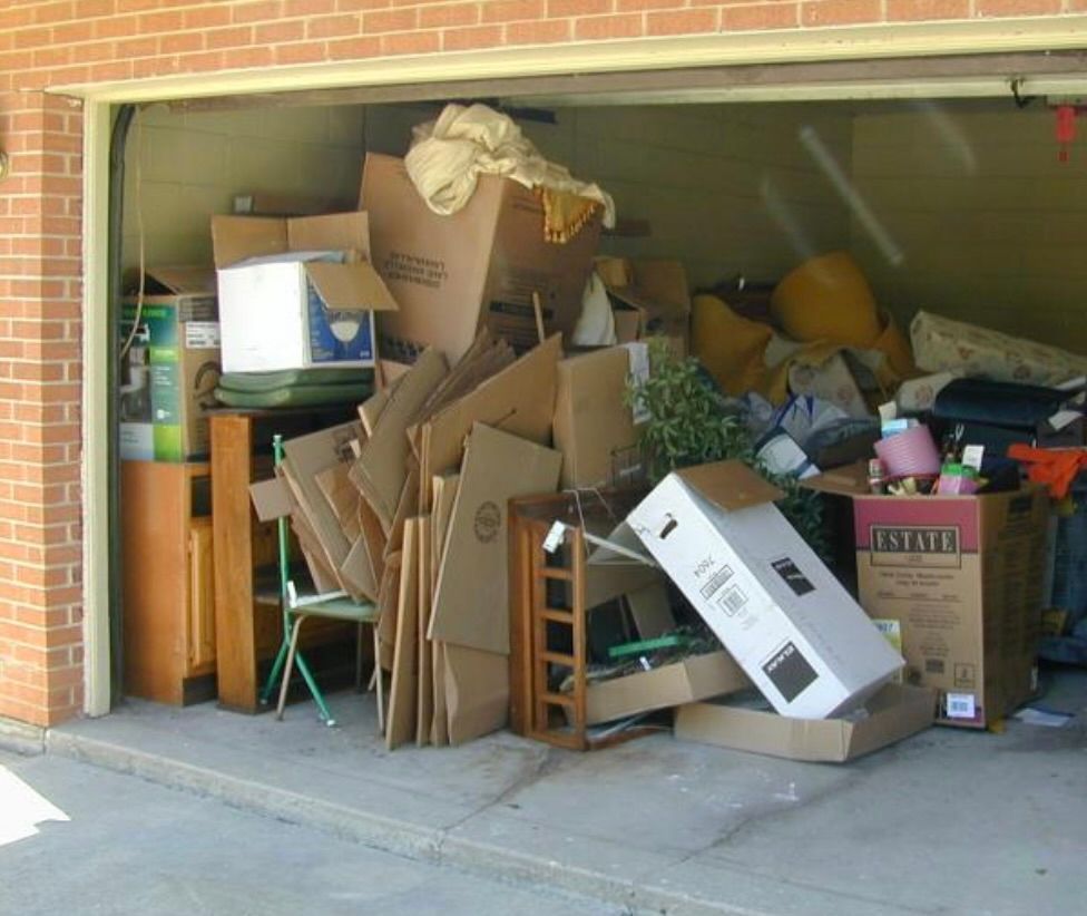 Woman and older woman smiling, indoors. Woman in red shirt, other in navy blazer.