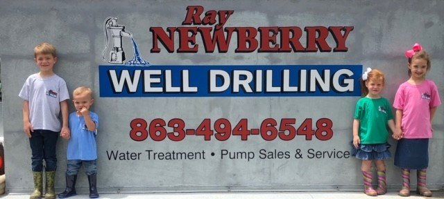 Kids Standing on the Signage — Arcadia, FL — Ray Newberry Well Drilling