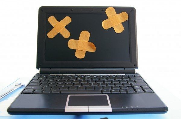 Laptop with sticking plasters on it