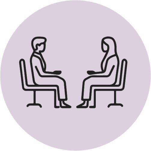 A line drawing of two people sitting face-to-face