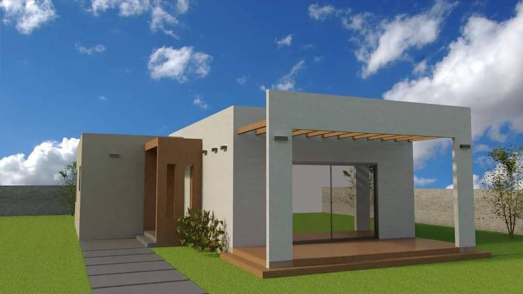 Modern white house with pergola, glass sliding doors, and green lawn under a blue sky.