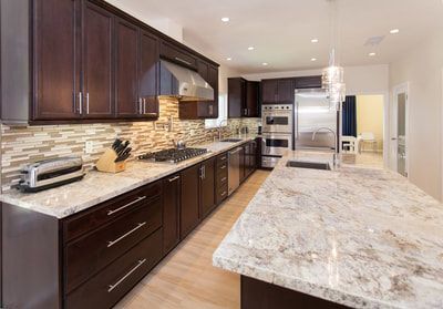 Dark wood kitchen with granite countertops and stainless steel appliances.