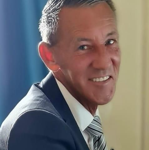 A Man and a Woman Are Looking at Urns in a Funeral Home — Bull Family Funerals in Inglewood, QLD