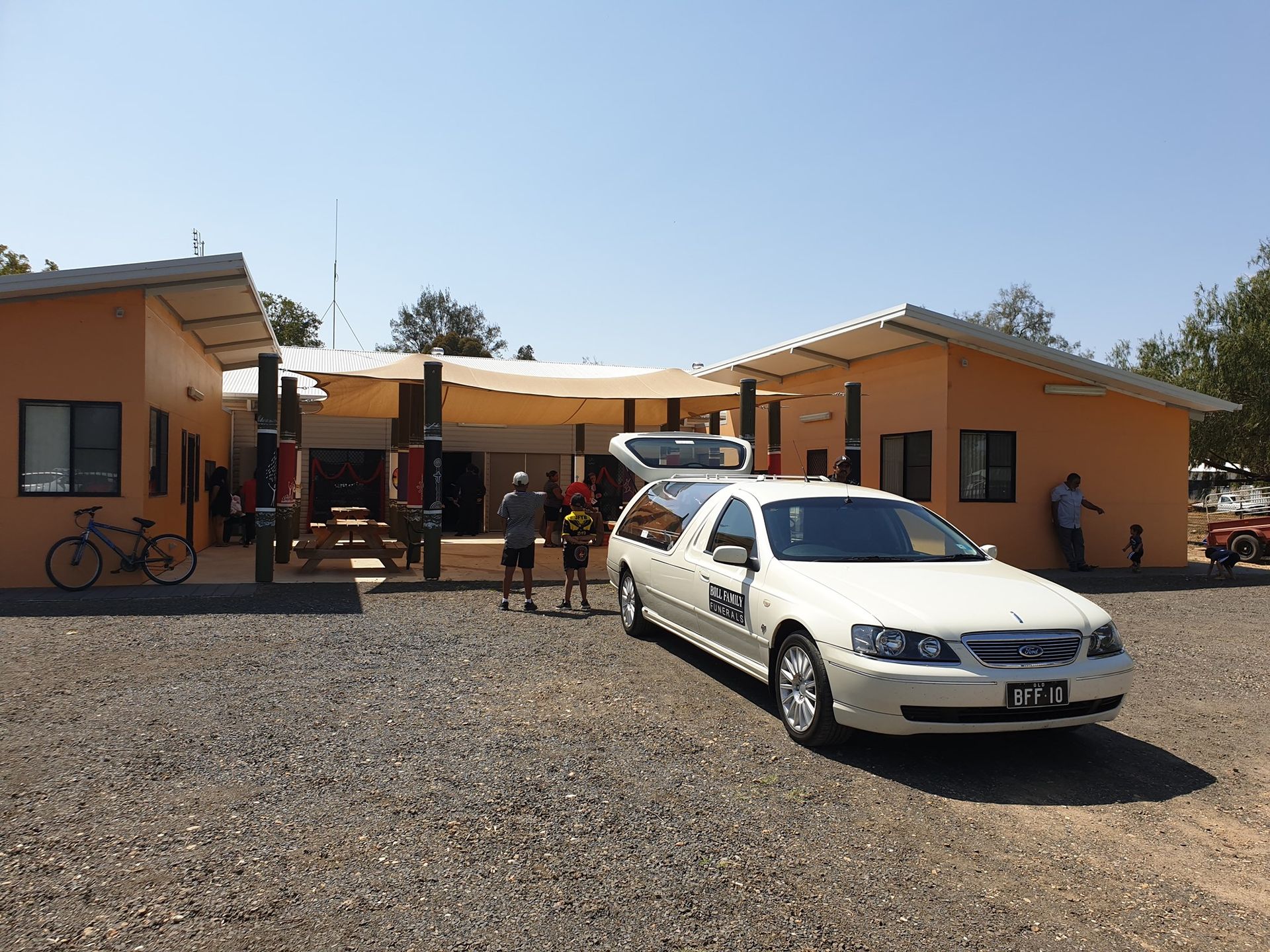 A Bunch of Flowers Are Sitting on a Rock in a Cemetery — Bull Family Funerals in Inglewood, QLD
