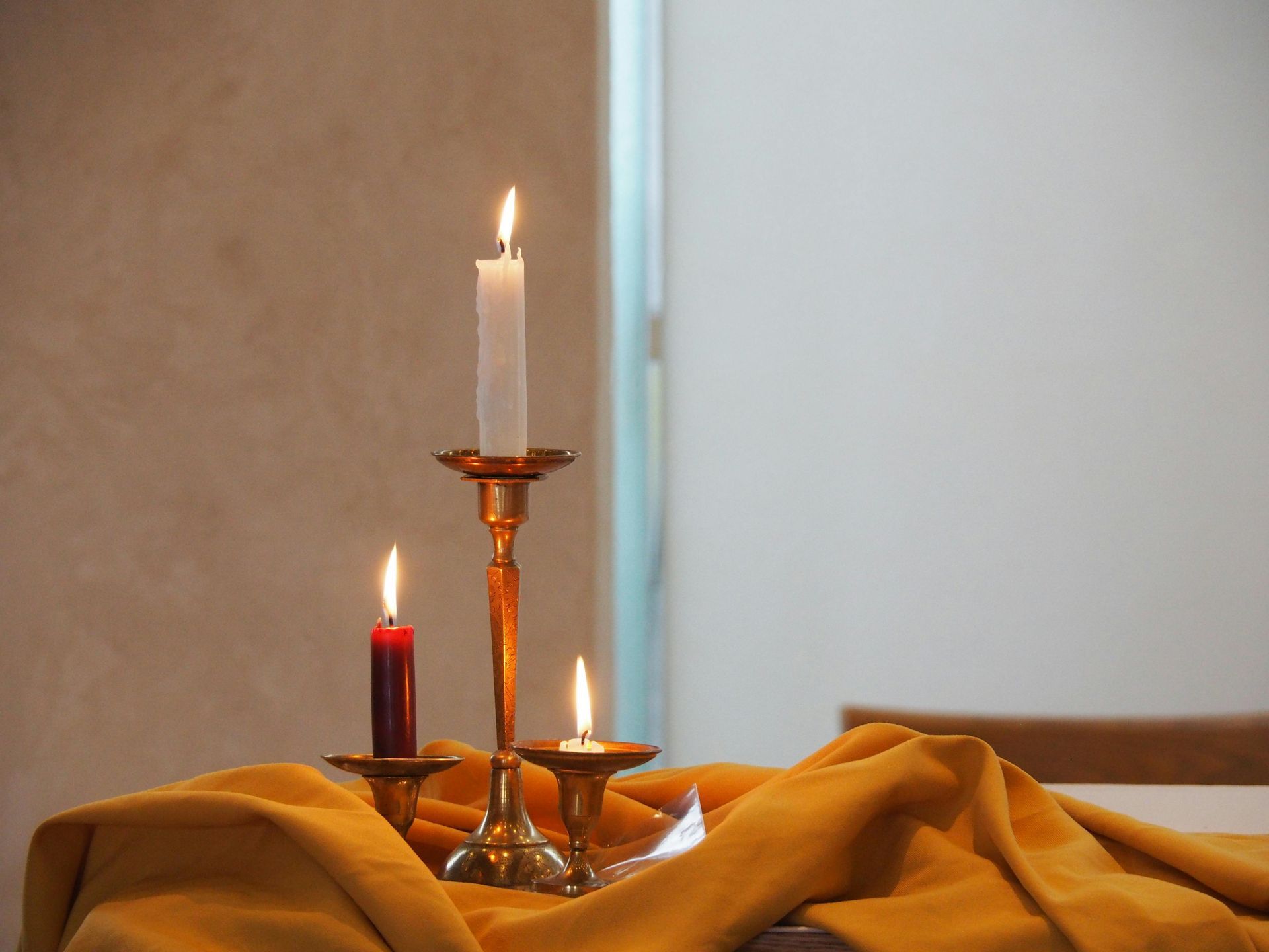 A White Urn is Sitting on a Table in Front of a Coffin — Bull Family Funerals in Inglewood, QLD