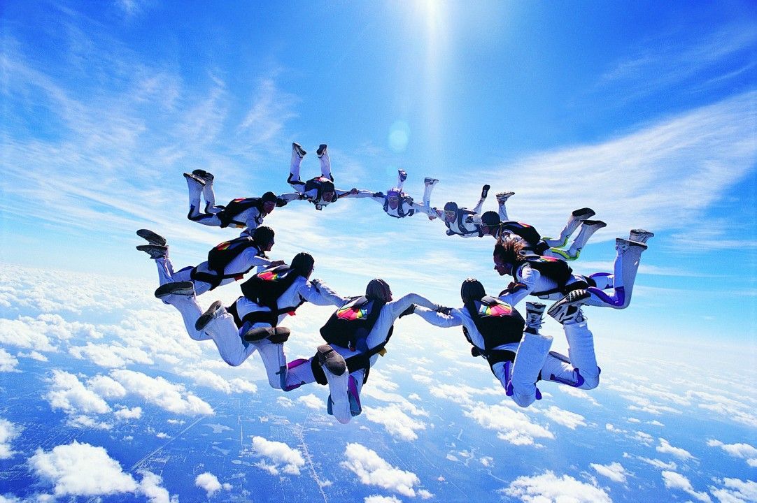 A group of people are flying through the air in a circle.