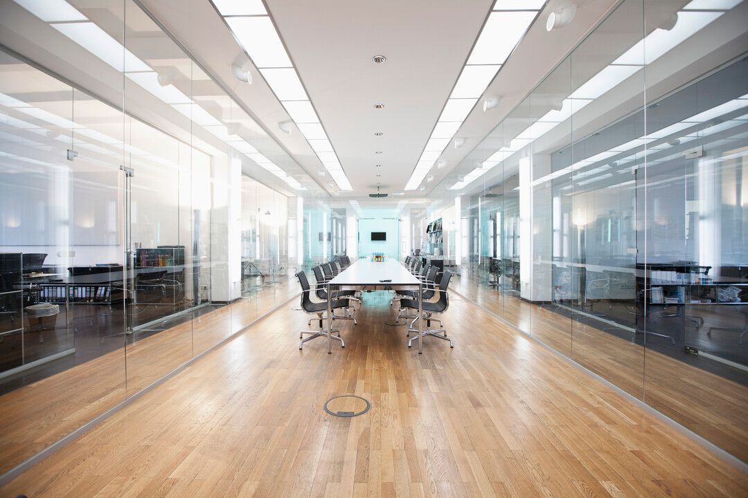 A conference room with a long table and chairs in an office building.