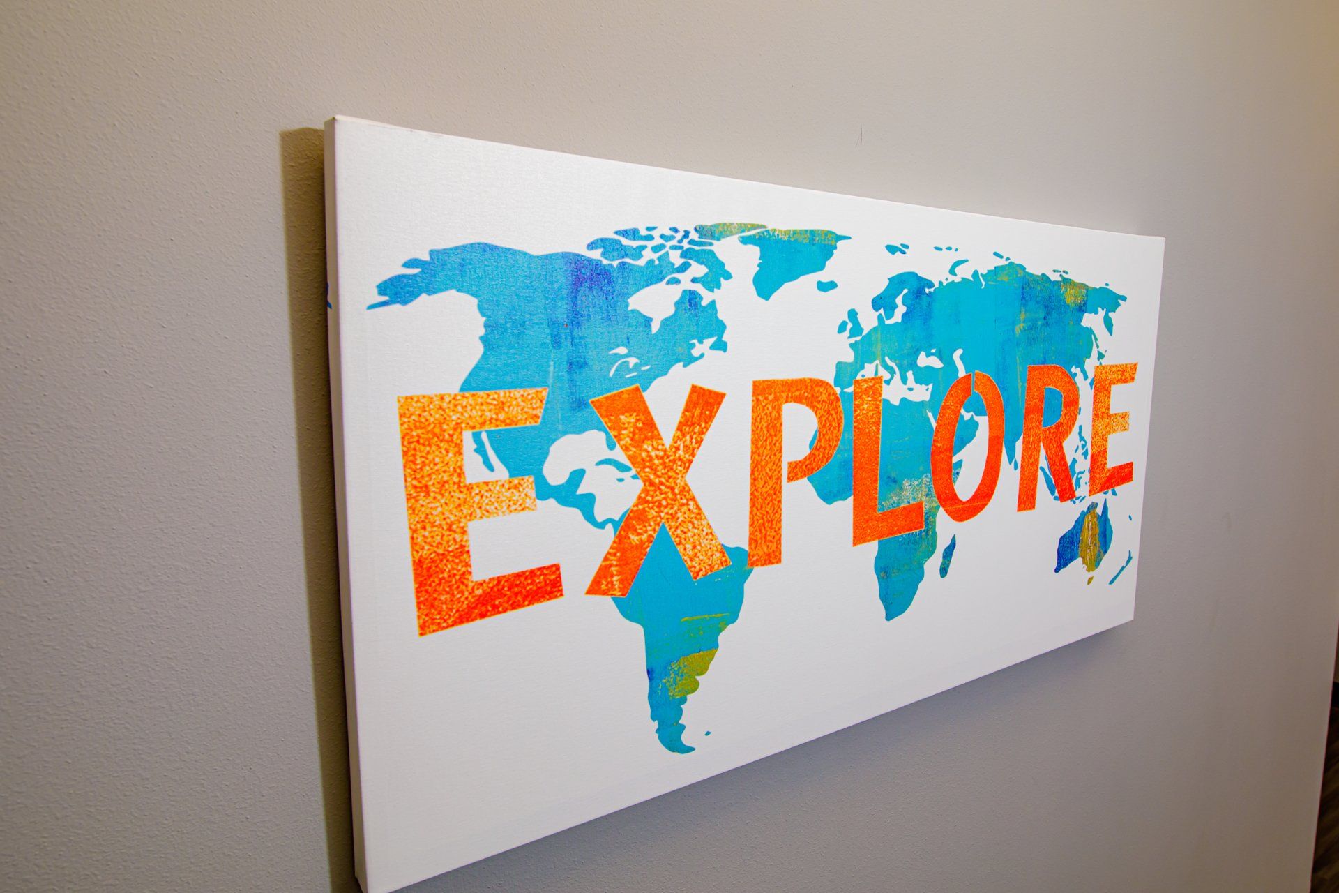 A canvas with a map of the world and the word explore on it.