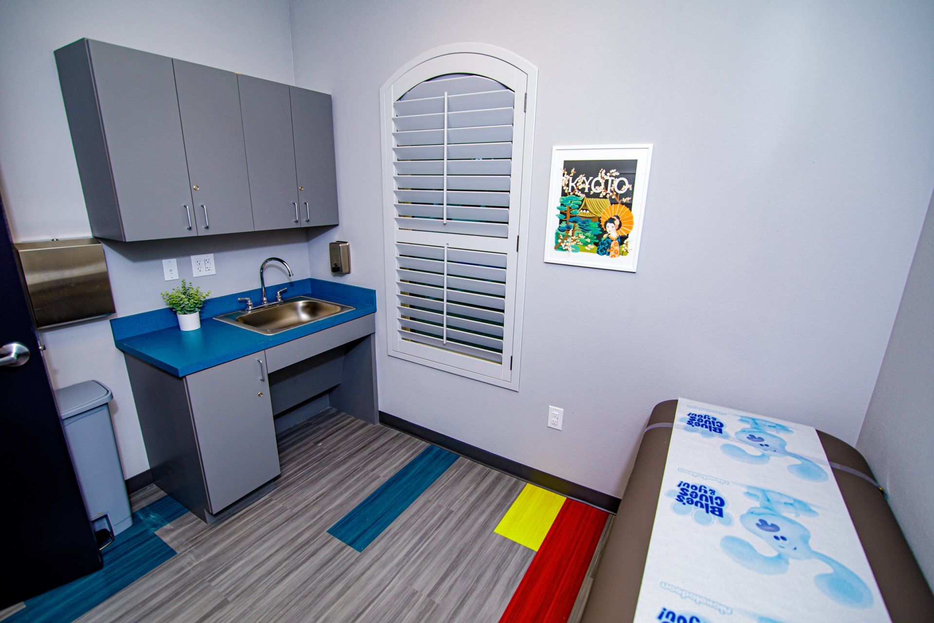 A room with a table and a sink in it.