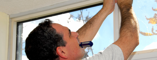 man installing new window