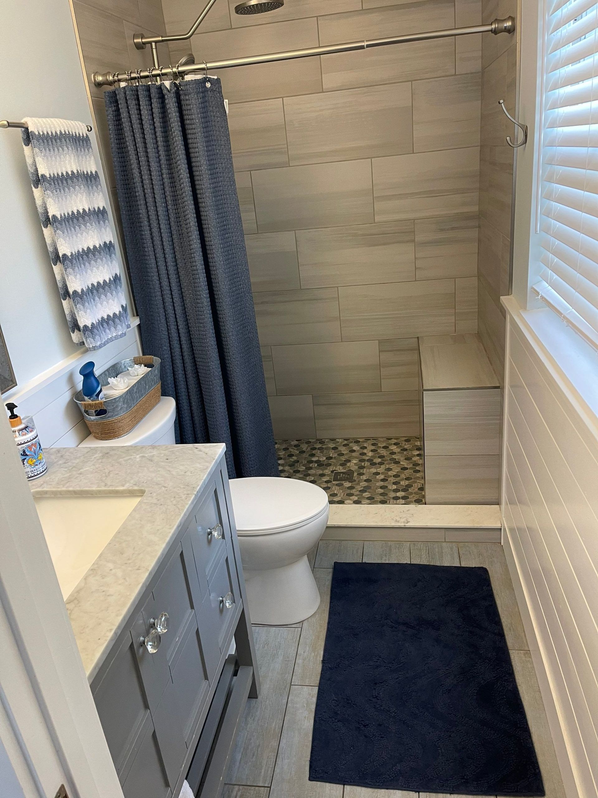 A bathroom with a toilet , sink , and shower.