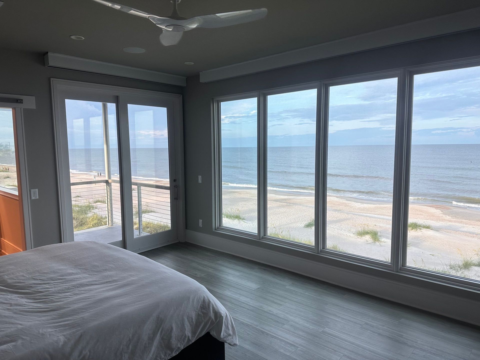 A bedroom with a bed and a view of the ocean.