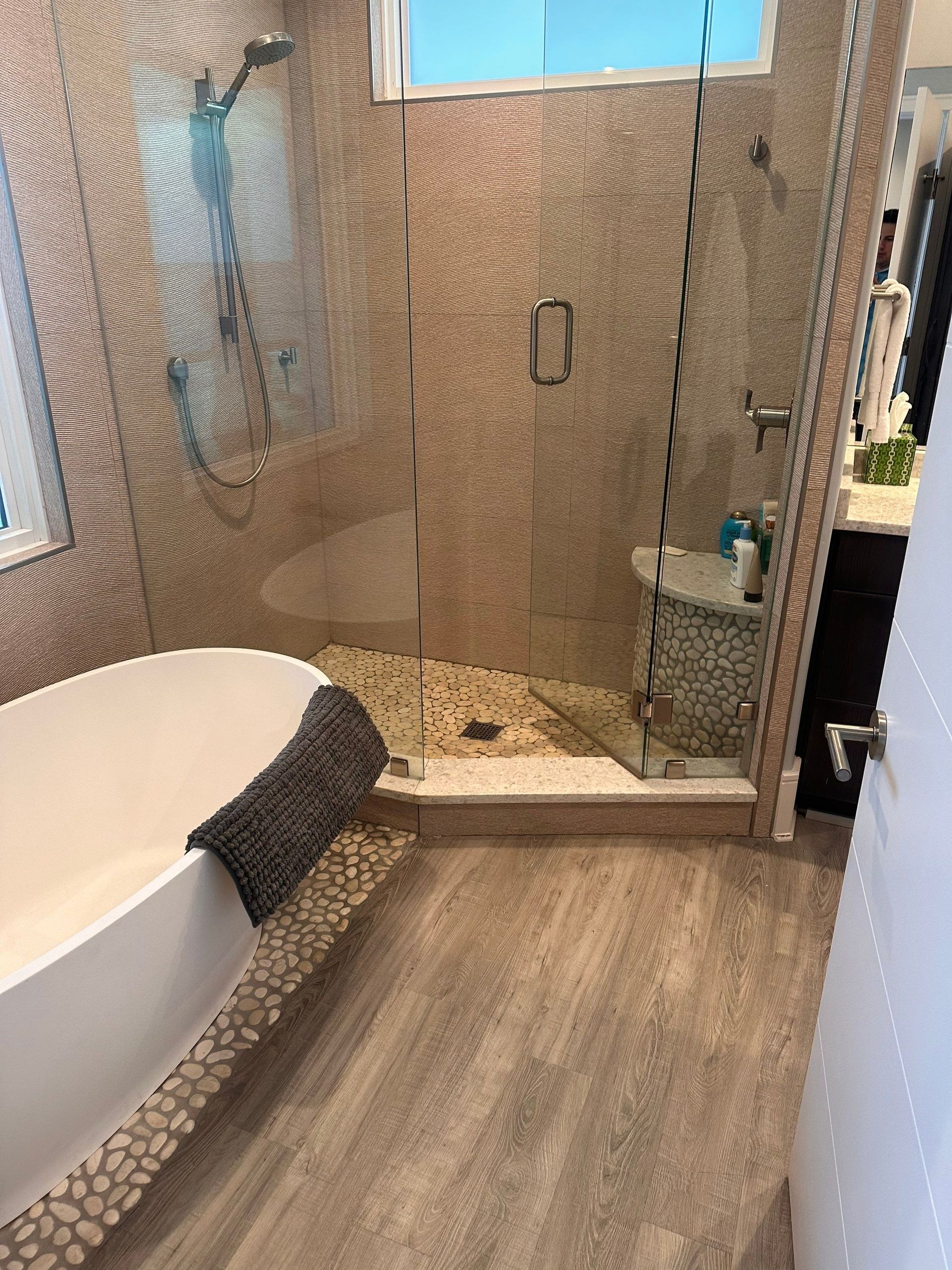 A bathroom with a tub and a walk in shower.