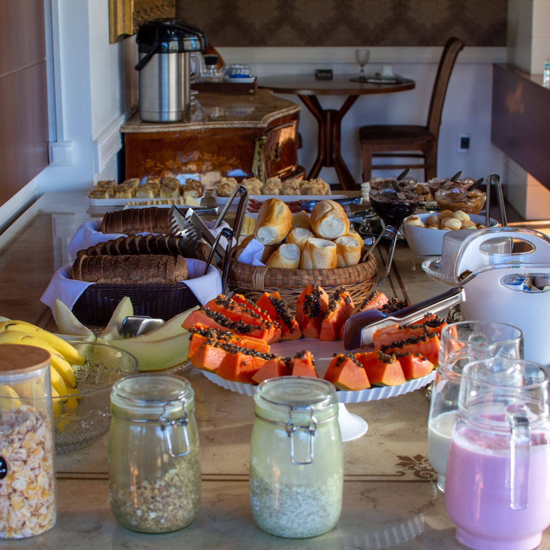 A table filled with a variety of food and drinks including a jar of chia seeds