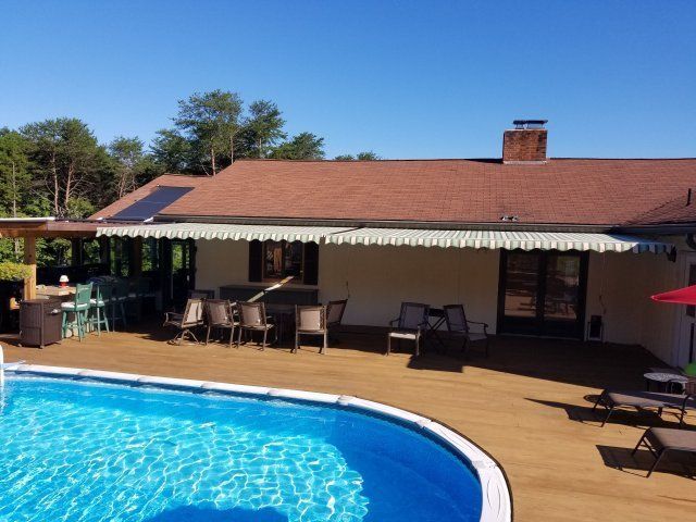 Handmade Retractable Awning Installation — House with Swimming Pool in Spartanburg, SC