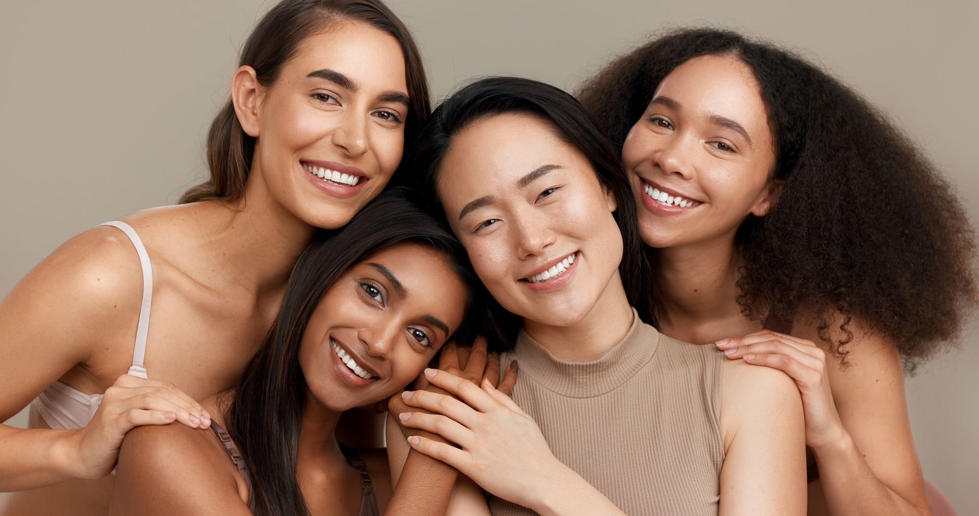 A group of women are posing for a picture together and smiling.