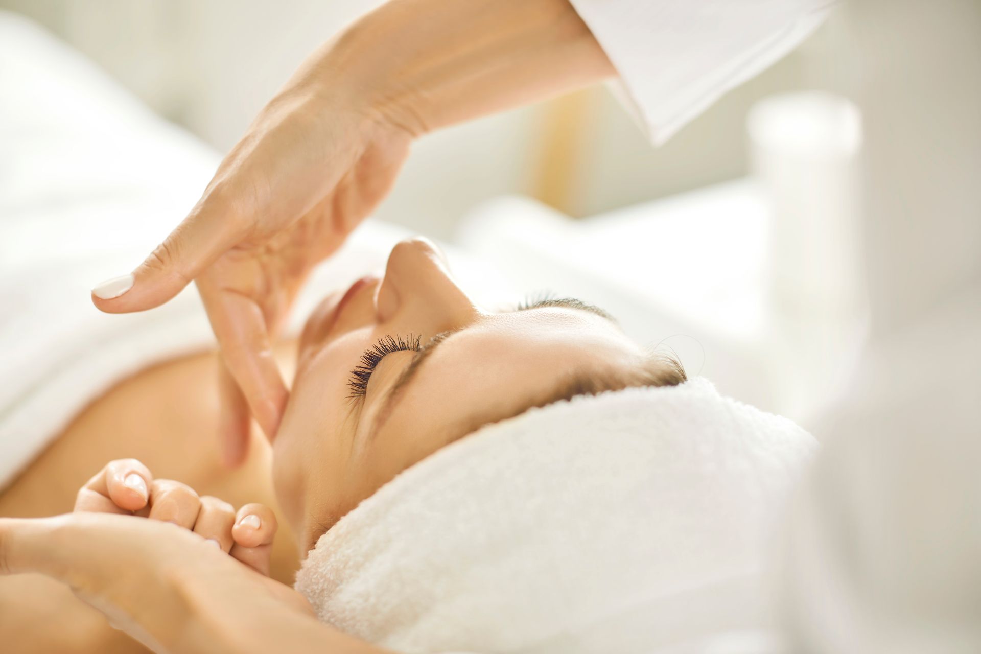 A woman is getting a facial treatment at a spa.