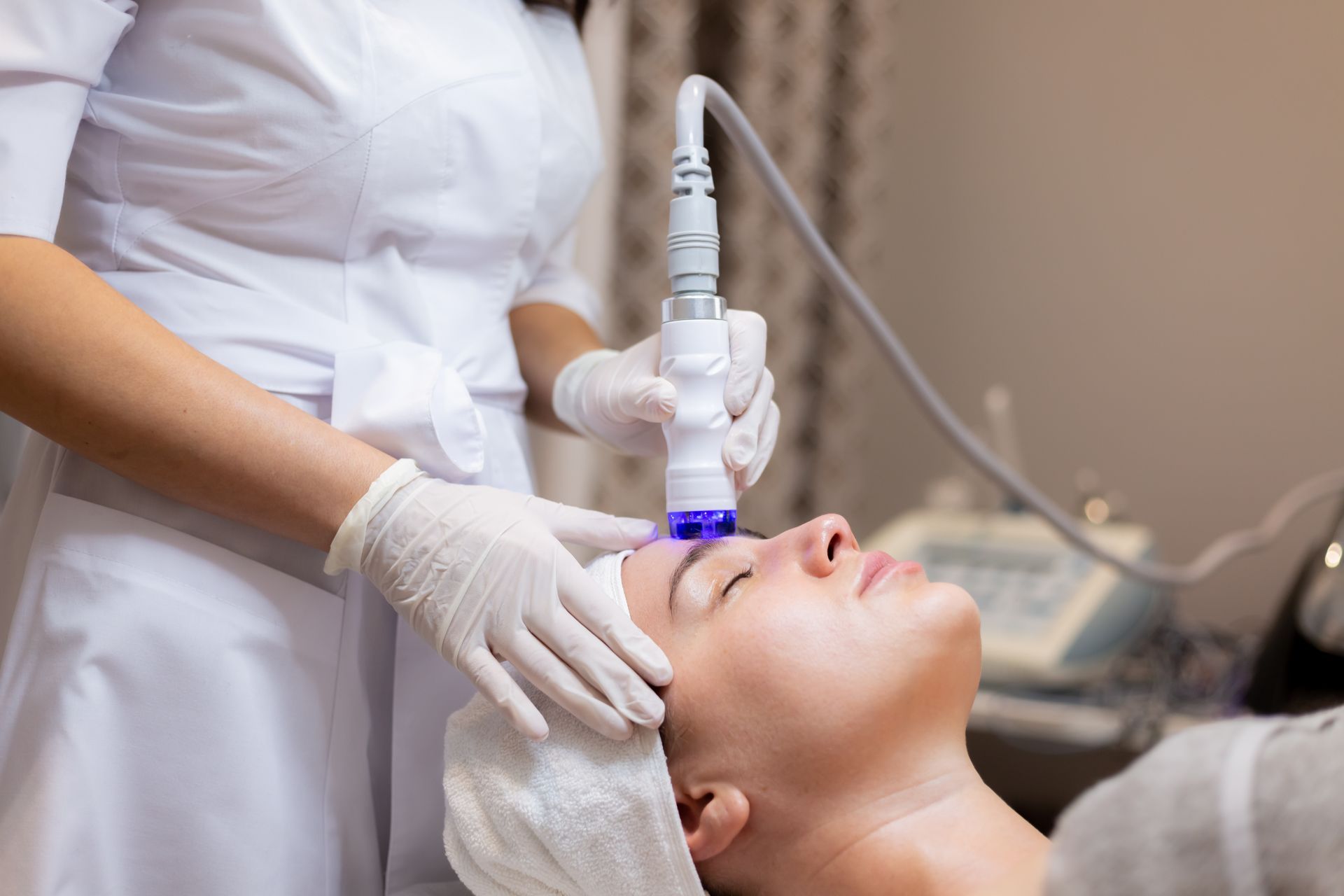 A woman is getting a facial treatment at a beauty salon.