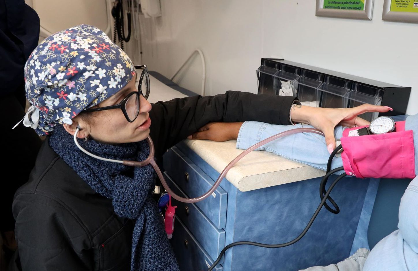 Care provider taking blood pressure of patient