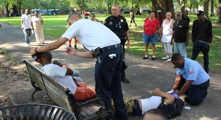First responders seek to revive victims passed out on the Upper Green during an overdose spike 8/18