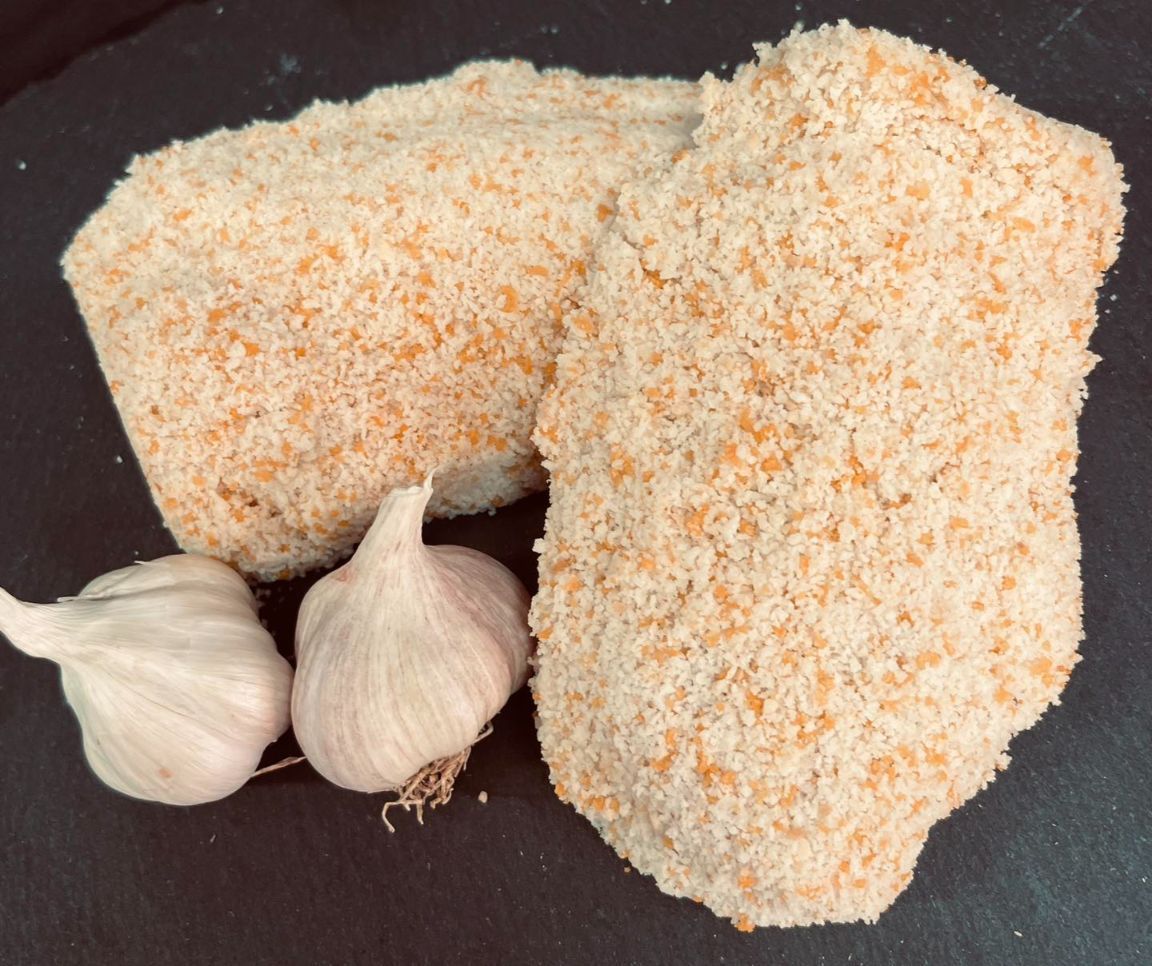 Two Pieces of Breaded Chicken and Garlic on a Table — MC Butchery in Moranbah, QLD