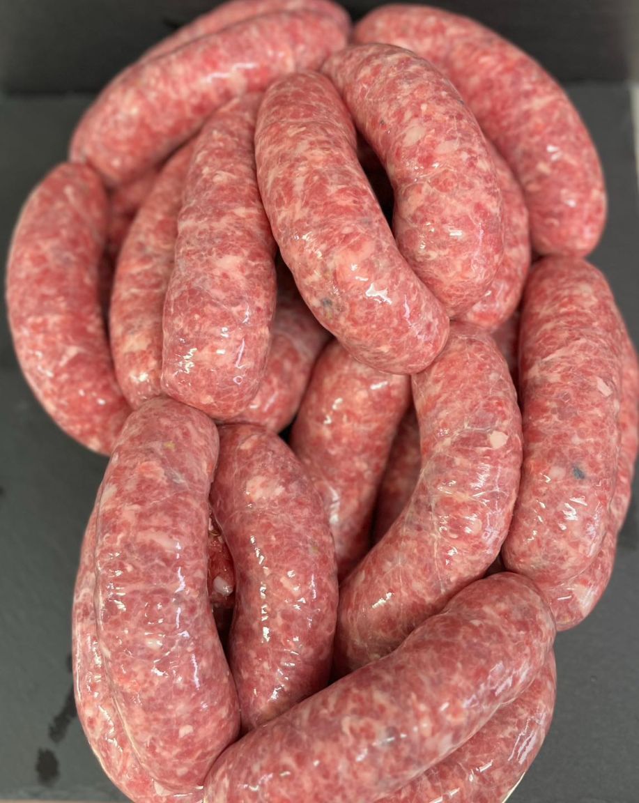 A Bunch Of Sausages Are Stacked On Top Of Each Other On A Table — MC Butchery in Moranbah, QLD