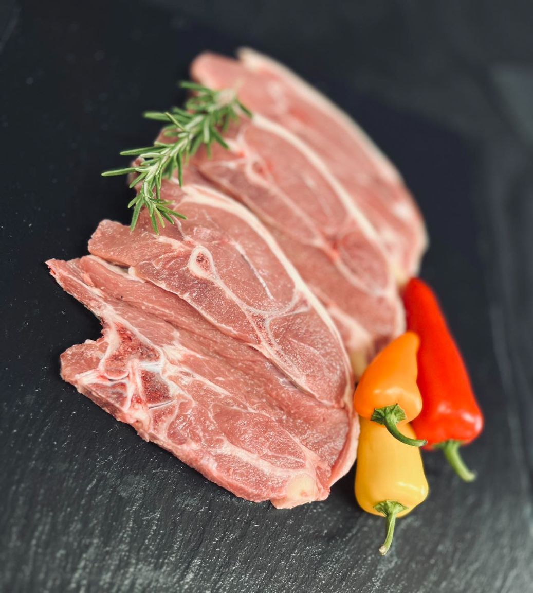 A Piece of Meat With Peppers and Rosemary on It — MC Butchery in Moranbah, QLD