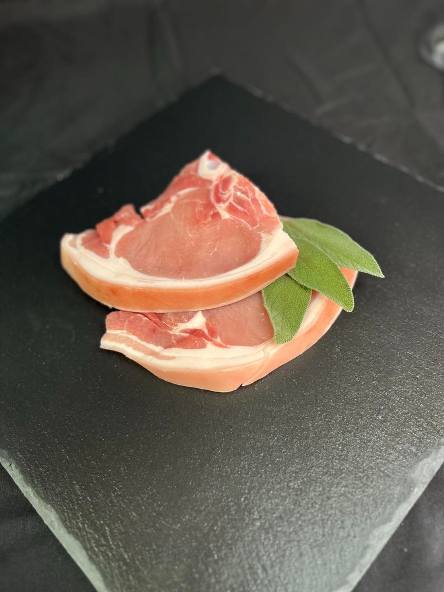 Two Pieces Of Meat Are Sitting On Top Of Each Other On A Black Plate — MC Butchery in Moranbah, QLD