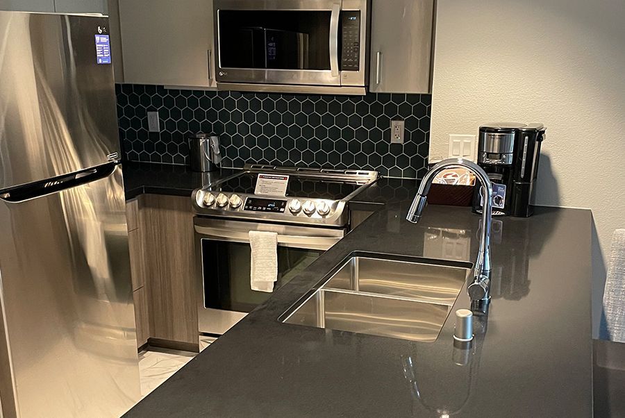 A kitchen with stainless steel appliances and a sink.