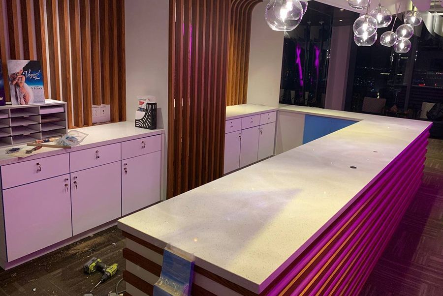 There is a long counter in the middle of the room.