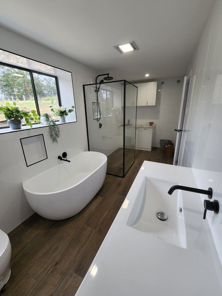 A Bathroom With A Bathtub And A Chair In It — Country 2 Coast Plumbing And Gas In Wauchope, NSW 