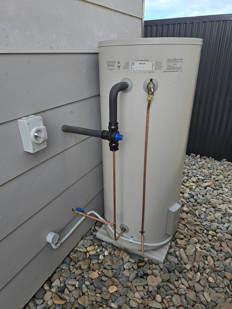 A Water Heater Is Attached To The Side Of A House — Country 2 Coast Plumbing And Gas In Wauchope, NSW 
