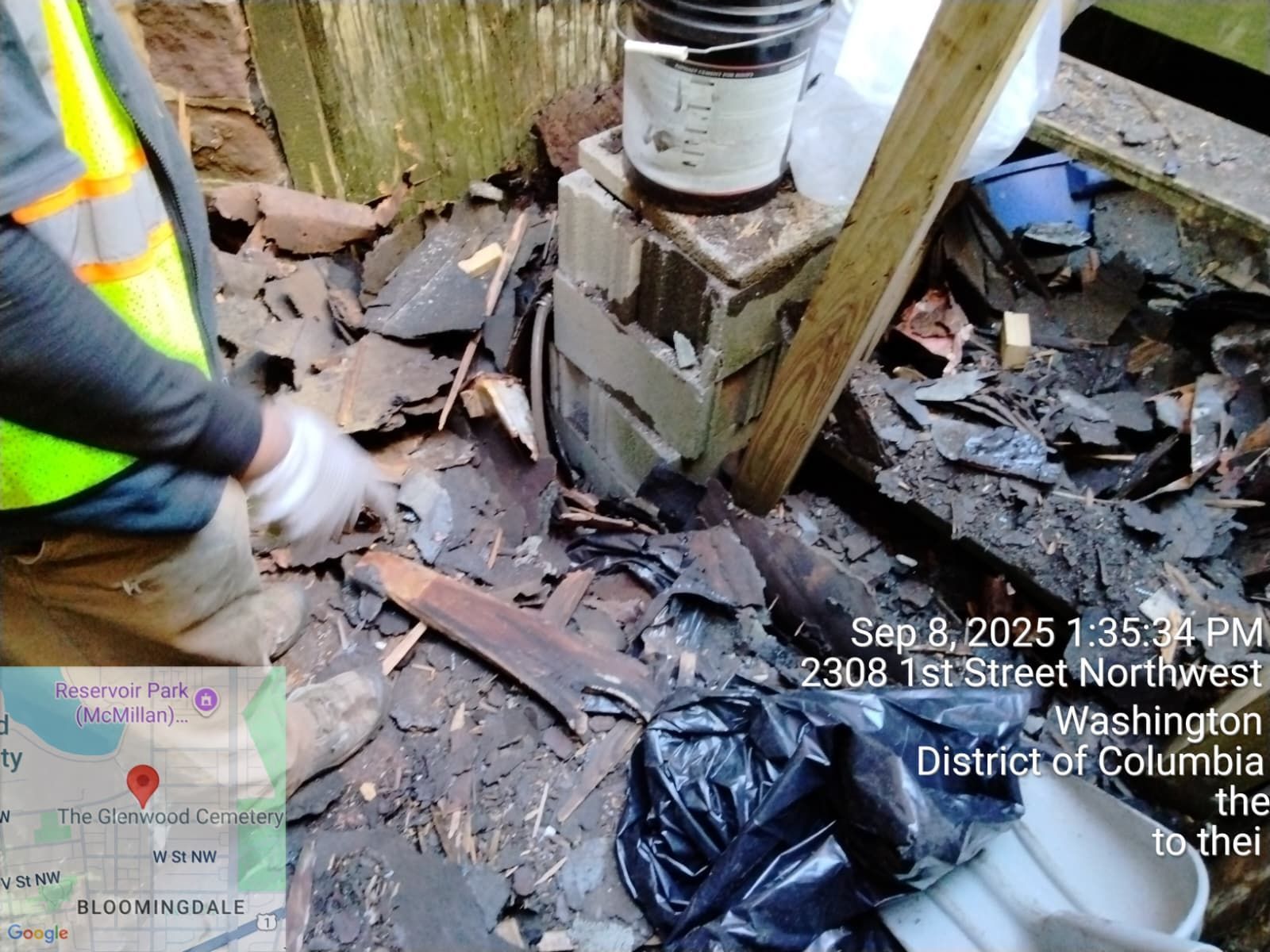 Person pointing at debris on a roof with a map inset, timestamp, and address (2308 1st Street Northwest, Washington DC)
