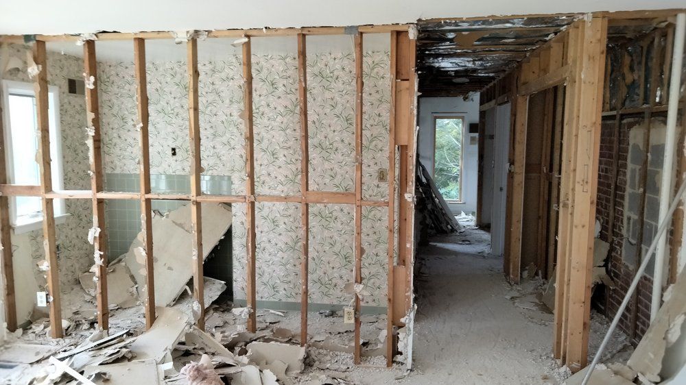 A room that is being remodeled with a staircase in the background