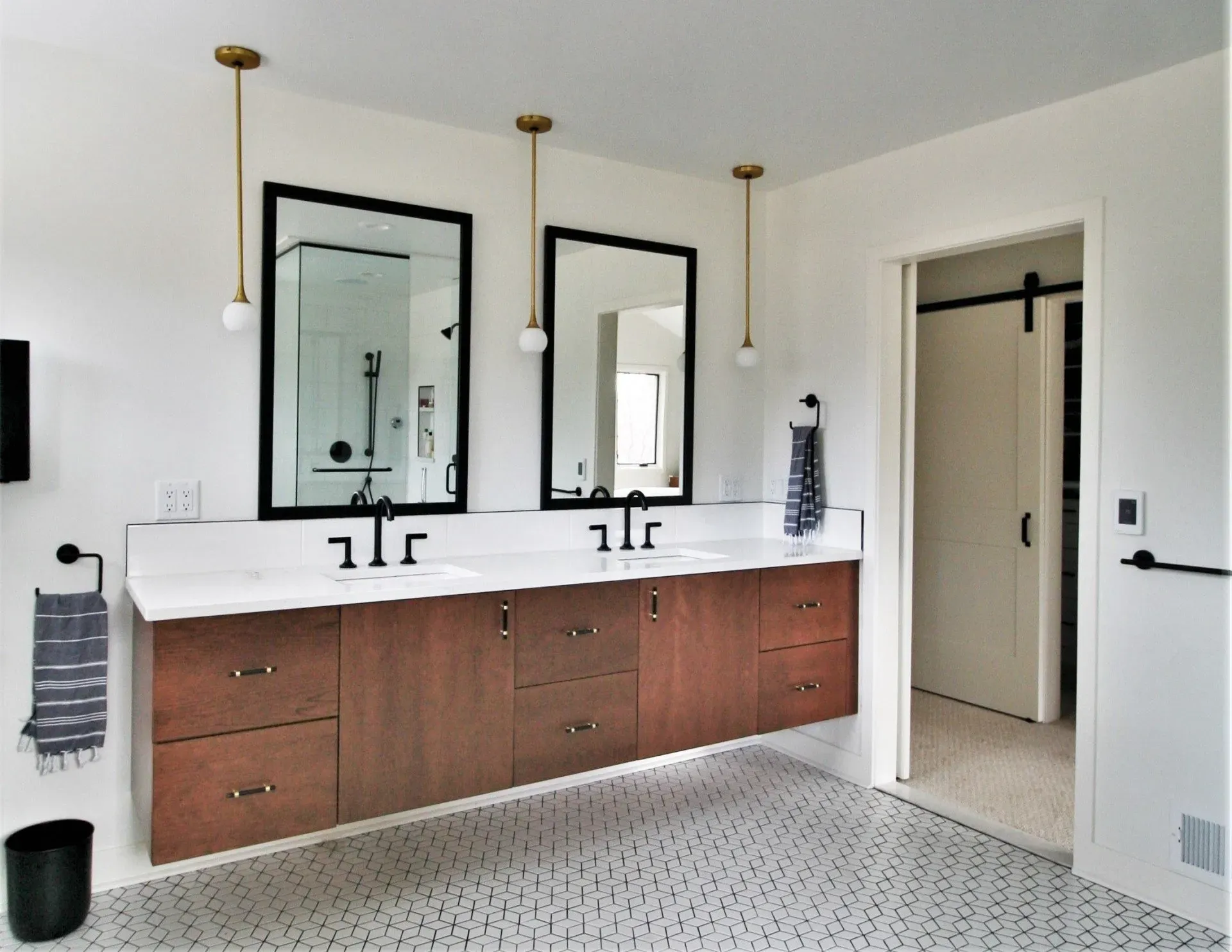A bathroom with two sinks and two mirrors