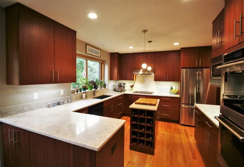 A kitchen with stainless steel appliances and wooden cabinets