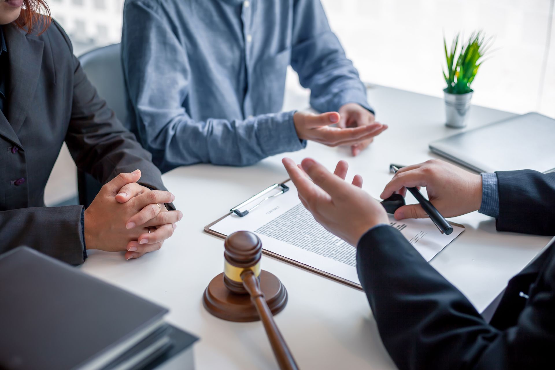 A lawyer explains a document to a couple at a table
