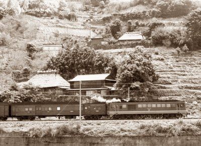 Old Dosan Line train passing a mountain village