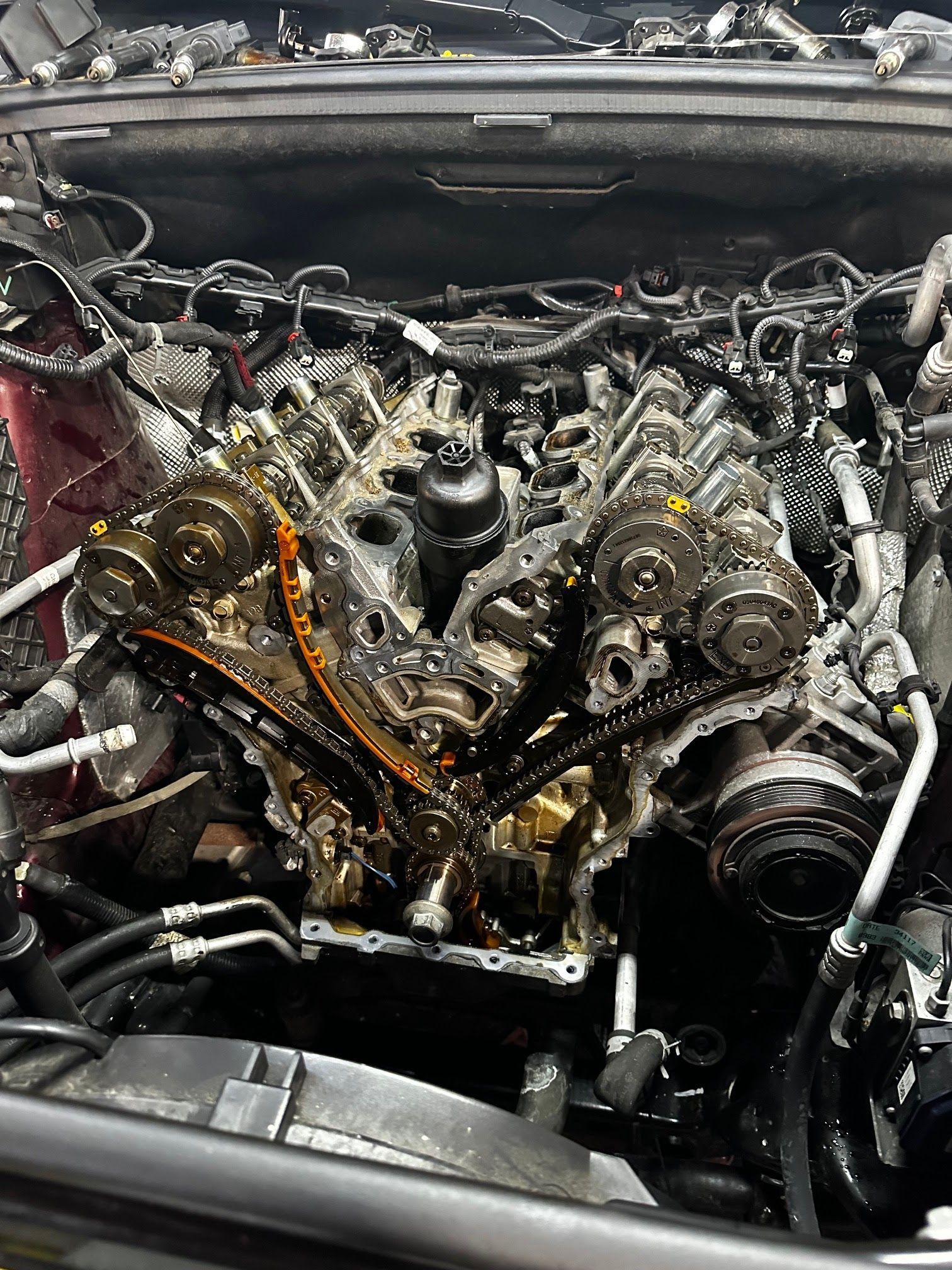 Open engine with timing chain, gears, and oil visible | Action Service Center