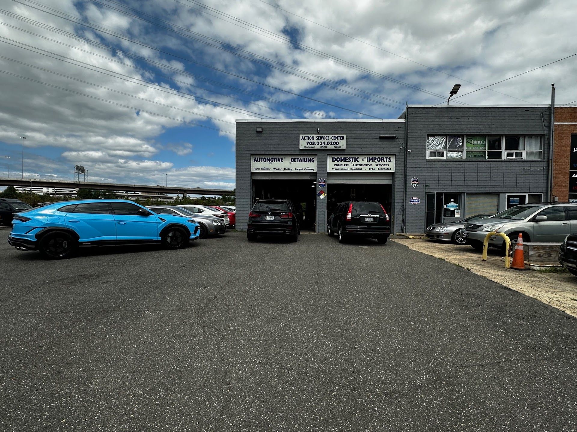 Exterior of an auto shop with cars parked outside | Action Service Center