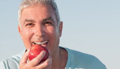 a man biting an apple