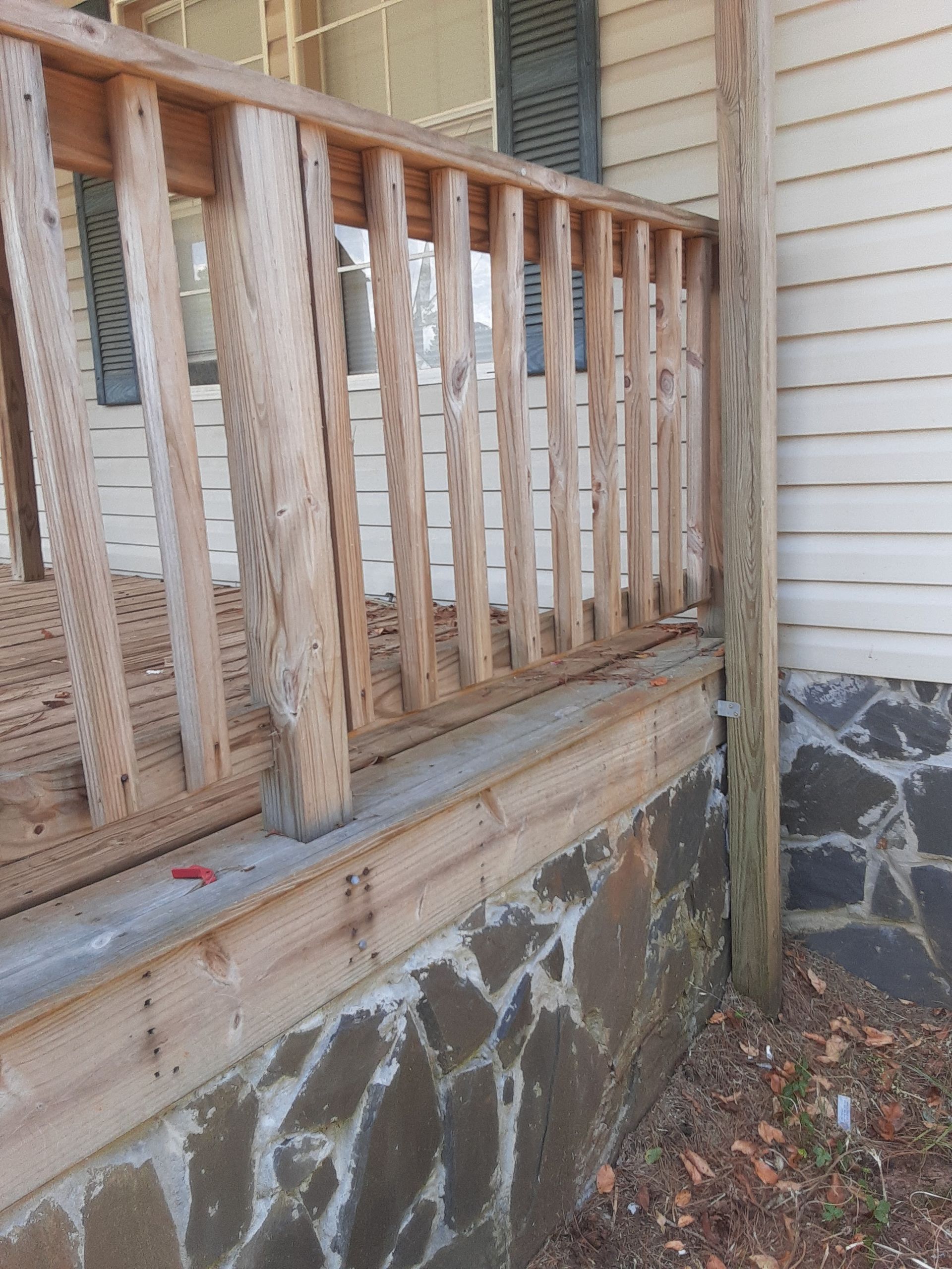 A wooden railing on the side of a house