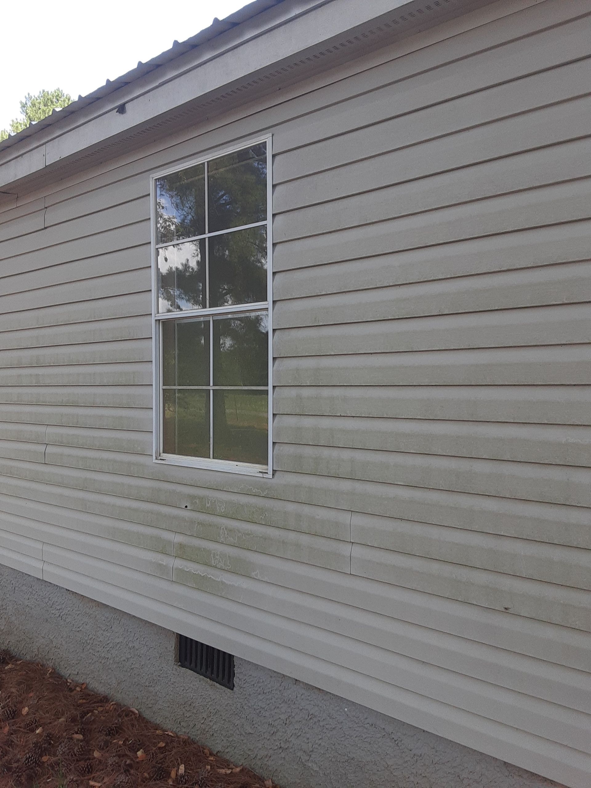 A white house with a window on the side of it