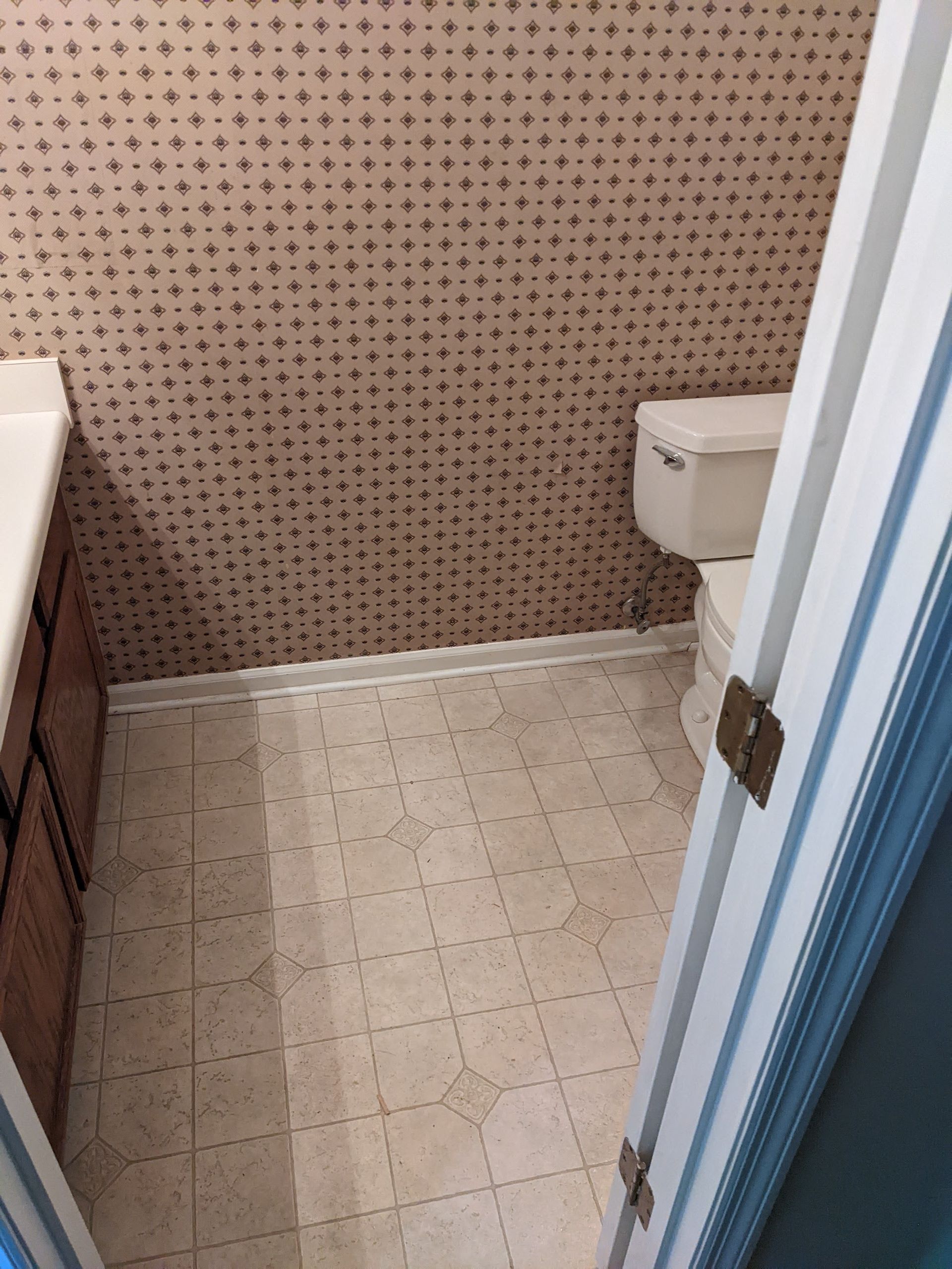 A bathroom with a toilet and a sink in it.