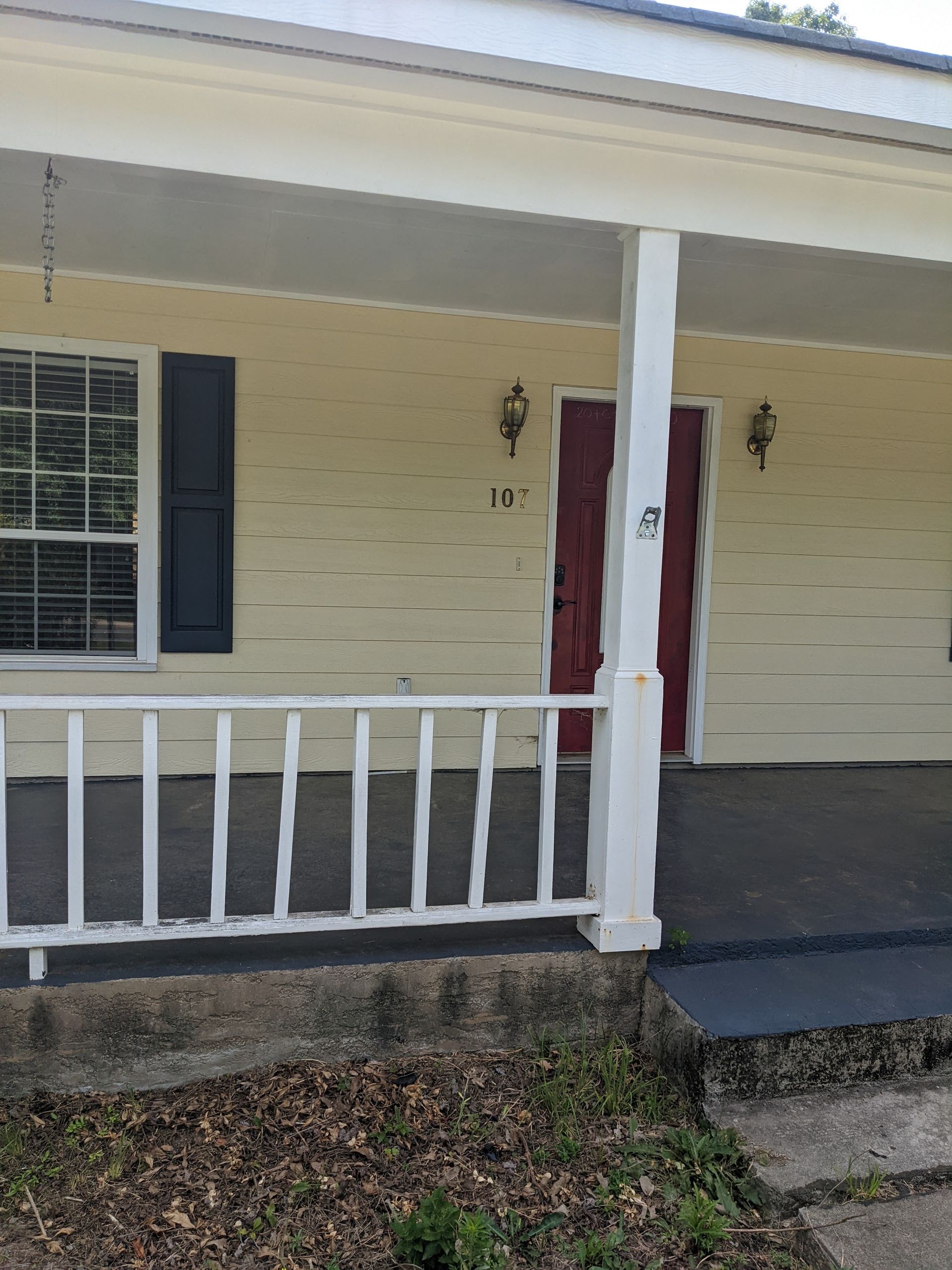 The front porch of a house with the number 11 on it