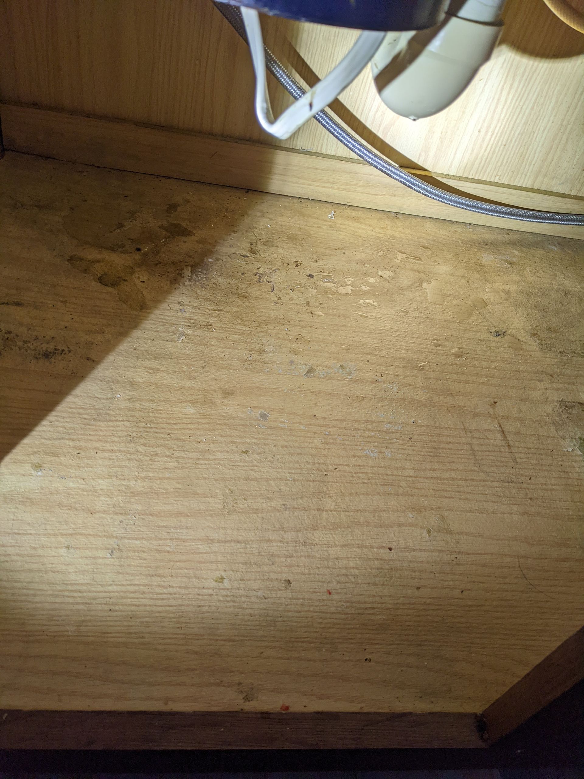 A close up of a wooden floor with a fan on it.