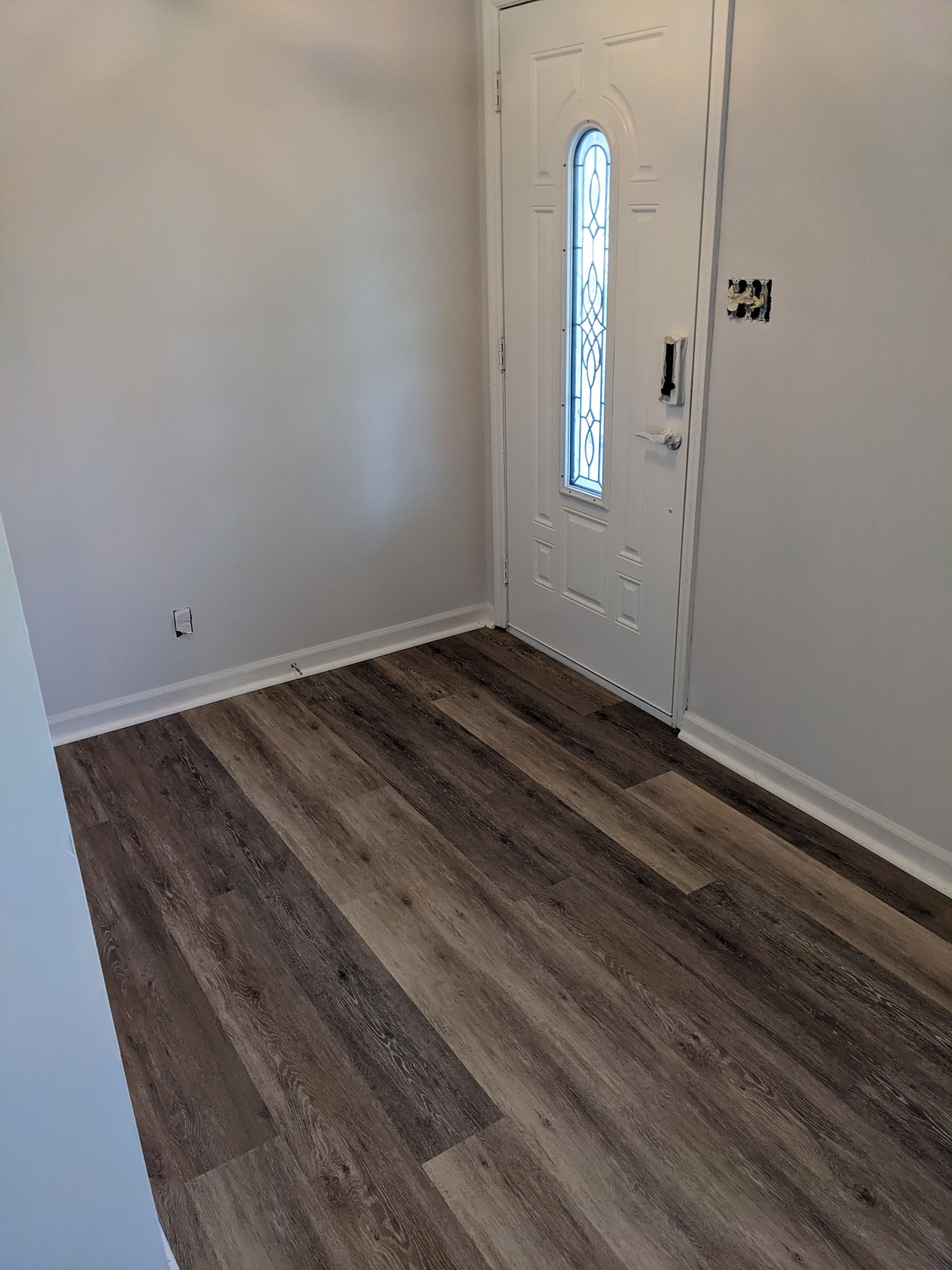 A room with hardwood floors and a white door.